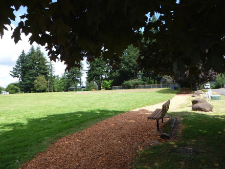 Along the main trail, there is a tree shaded bench to watch sports events - playground and picnic area are behind ball field